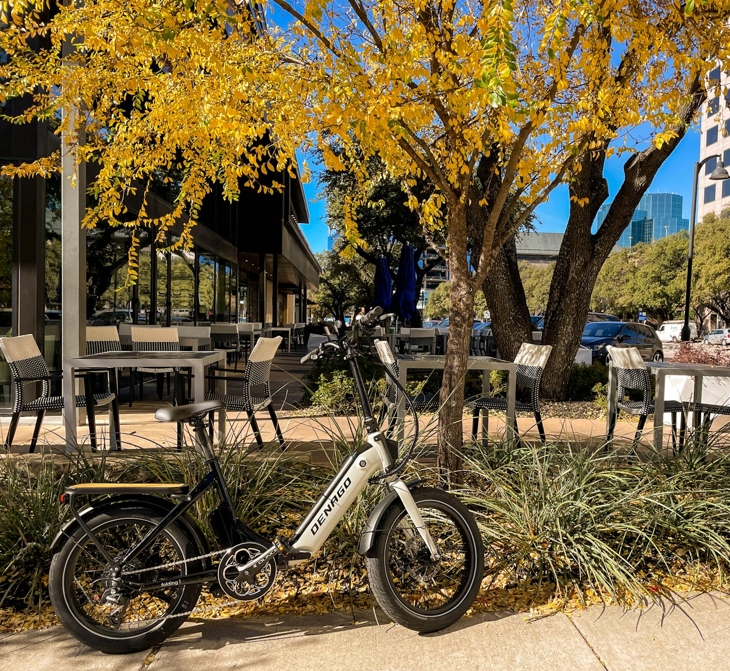 Una bicicleta eléctrica plegable aparcada en una acera de la ciudad.